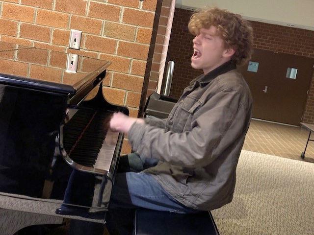 Levi Custer performs a song on piano.